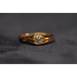 An 18ct gold single stone diamond ring. Central old cushion cut diamond, approximately 5mm in an