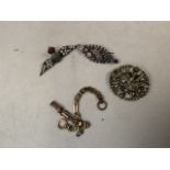 A white metal Scottish style brooch together with an unmarked yellow metal bracelet, a silver and
