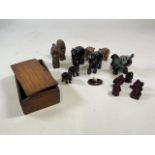 Collection of ornamental elephants with wooden box (a/f), resin figures and two carved heads