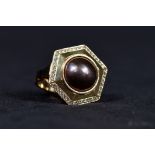 An 18ct gold South Sea black pearl and diamond ladies dress ring. Central 14mm pearl of golden