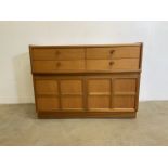 A mid century teak veneered sideboard by Nathan with four drawers above a cupboard.W:102cm x D: