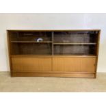 Herbert E Gibbs mid century bookcase, two sliding glass doors to shelves above sliding veneered