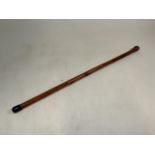 An Oriental style carved bamboo walking stick. Decorated with a snake wrapped around the cane and