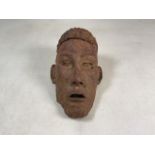 A 20th century cast metal face sculpture.