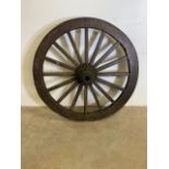 A large antique rustic wagon wheel possibly from a gun carriage. H:117cm