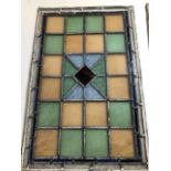 A pair of stained glass panels from a Devon long house, made by Swane Bourne, Birmingham m. One pane