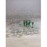 A large collection of cut and etched glass to include four Sherry glasses, six liqueur glasses,