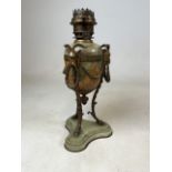 A green onyx and brass oil lamp with brass swags, ram heads and hoofs. Marked RV and an anchor. W: