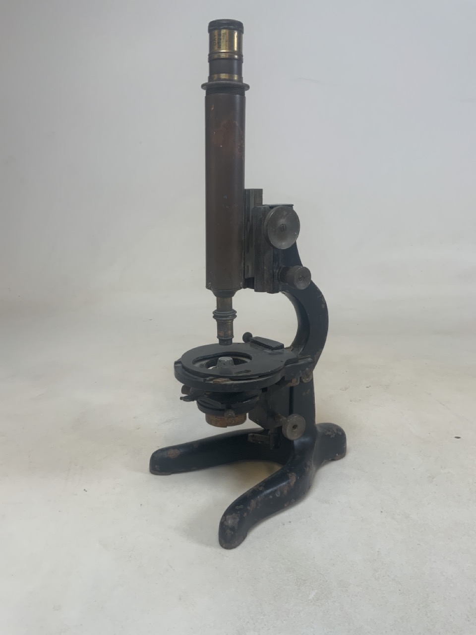 A military issue mid 20th century horse shoe based microscope, with broad arrow stamp. H:43cm