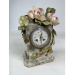 A ceramic mantle clock decorated with pink roses and leaves marked P 388 underneath. W:22cm x D:13cm