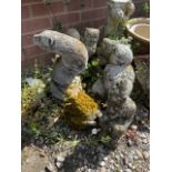 Stone animals and a garden gnome. Animals include: deer, owls, frogs and a otter.