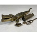 A collection of brass ware, mourning brooch, spy glass, badges and a large brass crocodile nut