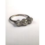 A platinum and diamond three stone ring. centrally set with 6mm old cut diamond with two 5mm old cut