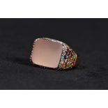 An 18ct gold ladies dress ring centrally set with oblong rose quartz cabochon with a surround of