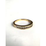 An 18ct gold half eternity ring with tension set line of 10 single cut diamonds. 3.1g. Size M.