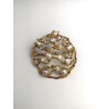 A 1970s 18 ct gold pearl and diamond abstract open work brooch, Set throughout with baroque pearls