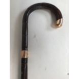 A bamboo walking stick with 9ct gold top also with 9ct collar H:86cm