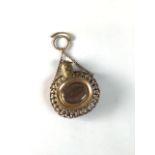 A Georgian memorial scent bottle pendant in the Etruscan style. Centrally set with quartz panels