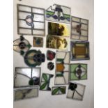 A collection of stained glass pieces and two painted tiles including one of Pembroke Castle, Wales