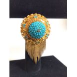 An antique unmarked yellow metal diamond and turquoise Etruscan style wheel brooch. Centrally set