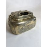 An Oriental cast brass censer or cricket box with raised birds in fauna decoration, pierced lid with