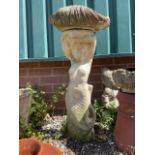 A mermaid figure stand with a shell shaded bird bath. H:70cm