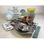A collection of kitchenalia to include Pyrex, stainless steel serving tableware, co op stamp books