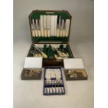 A six person boxed set of flatware with faux ivory handles together with three boxed sets of