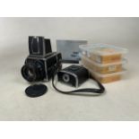 A Hasselblad 500c/m medium format camera with a Carl Zeiss f=80mm, 1:2,8. Plus two camera backs,