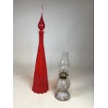 A mid century red ribbed art glass bottle H:69cm together with a marbled glass oil lamp H:36cm