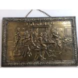 A brass beaten wall plaque with action packed interior pub scene.