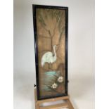 Oriental painting of stork in landscape on canvas in simulated bamboo frame.