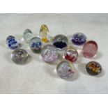 A collection of eleven glass paper weights