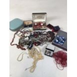 A quantity of costume jewellery, watches and badges.