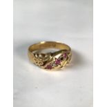 An 18ct gold ruby and diamond ring. Three small single cut rubies with two single cut diamonds(one
