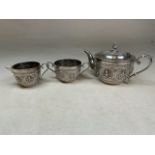 An Indian silver bachelors tea set with repousse decoration stamped to base Silver T.R Tawker and