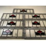 Seven stained glass panels of tulips and green leaves. Largest W:50cm x H:17cm. Smallest W:42cm x
