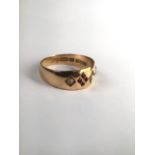 A 15ct gold band set with free cut rubies and split pearls. 2.5g. Size l.5. m