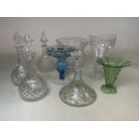 A collection of glassware to include three decanters with stoppers, green glass vase, Polish blue