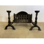 A pair of large heavy metal fire dogs and grate. W:95cm x D:66cm x H:47cm