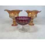 Two carnival glass vases and a cranberry glass comport