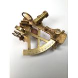 A brass sextant in wooden box