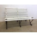 A Victorian garden bench with painted wooden slats with metal ends and middle support.