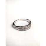 A platinum and diamond half eternity ring set with double line of brilliant cut diamonds. 4.8g. size
