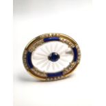 An 18ct gold sapphire, diamond and quartz crystal brooch. Cenrally set with round cut sapphire