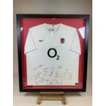 A signed team shirt by the 2011 England rugby team. Includes Johnny Wilkinson and Manu Tuilagi W: