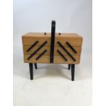 A mid century cantilever sewing box on legs W:43cm x D:21cm x H:46cm