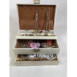 A jewellery box with costume jewellery to include necklaces, metal bracelets, local interest pins