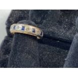 A 9ct gold full eternity ring set with square cut sapphires. 3.3g size L.