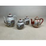 Two oriental teapots, a milk jug and a sugar bowl